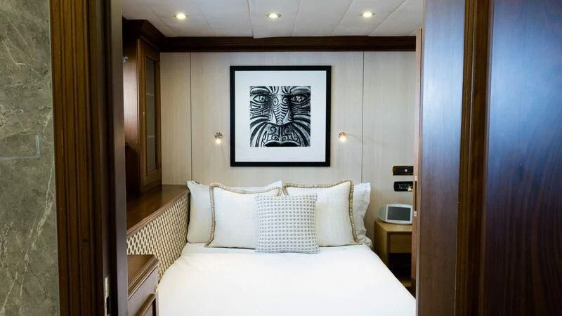a bed with white sheets and pillows aboard IRAMA Yacht for Sale