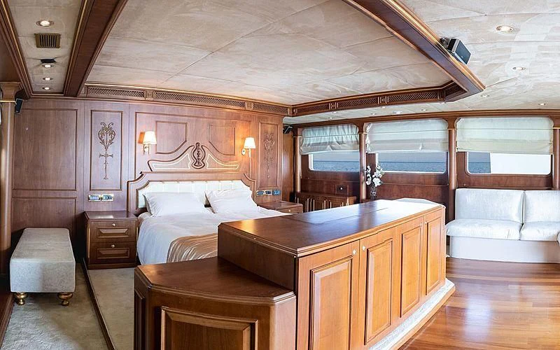 a room with a bed and a desk aboard IRAMA Yacht for Sale