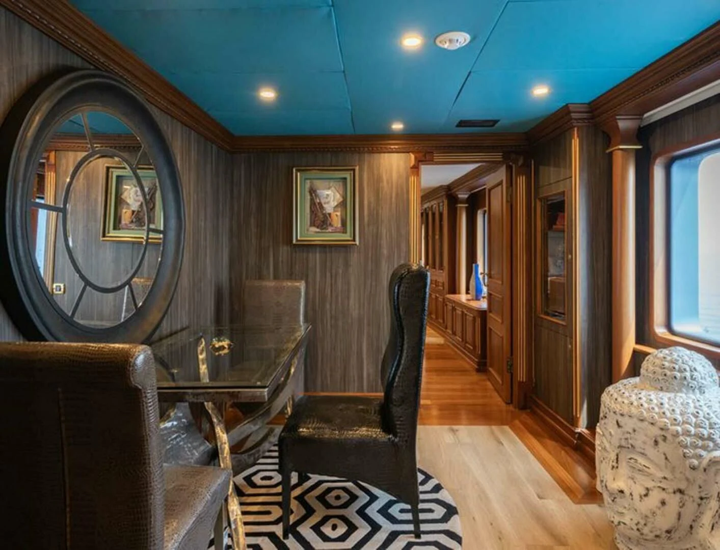 a living room with a wood paneled wall aboard IRAMA Yacht for Sale