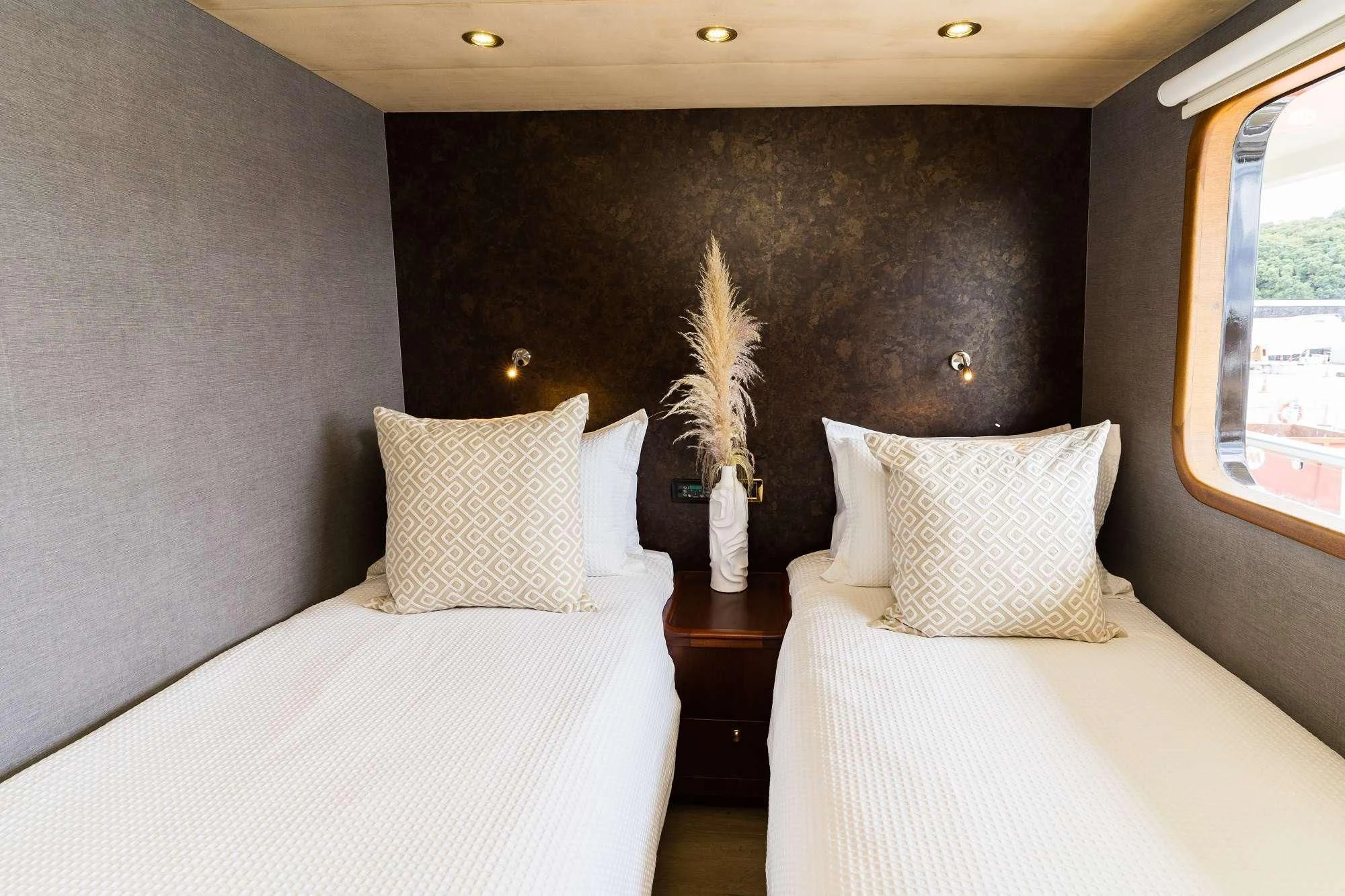 a room with two beds aboard IRAMA Yacht for Sale