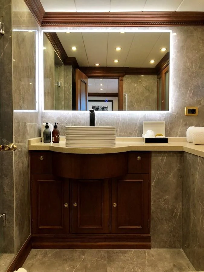 a bathroom with a large mirror aboard IRAMA Yacht for Sale