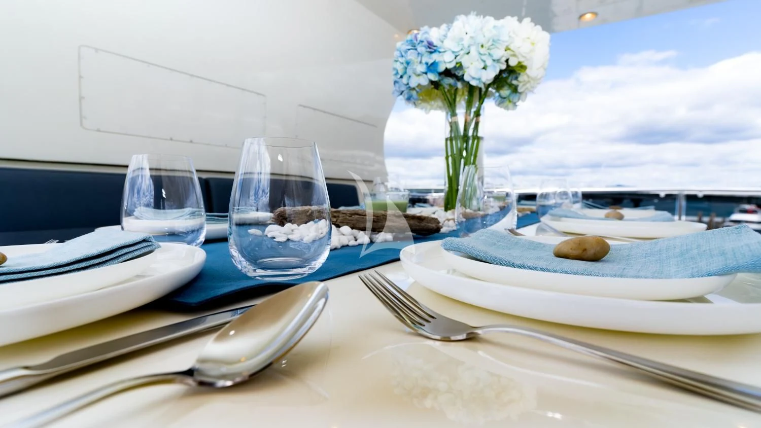 a table with plates and glasses aboard IRAMA Yacht for Sale