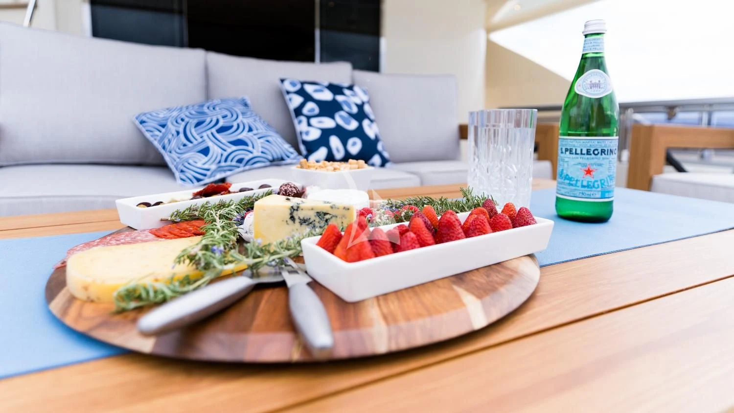 a plate of food and a bottle of water aboard IRAMA Yacht for Sale