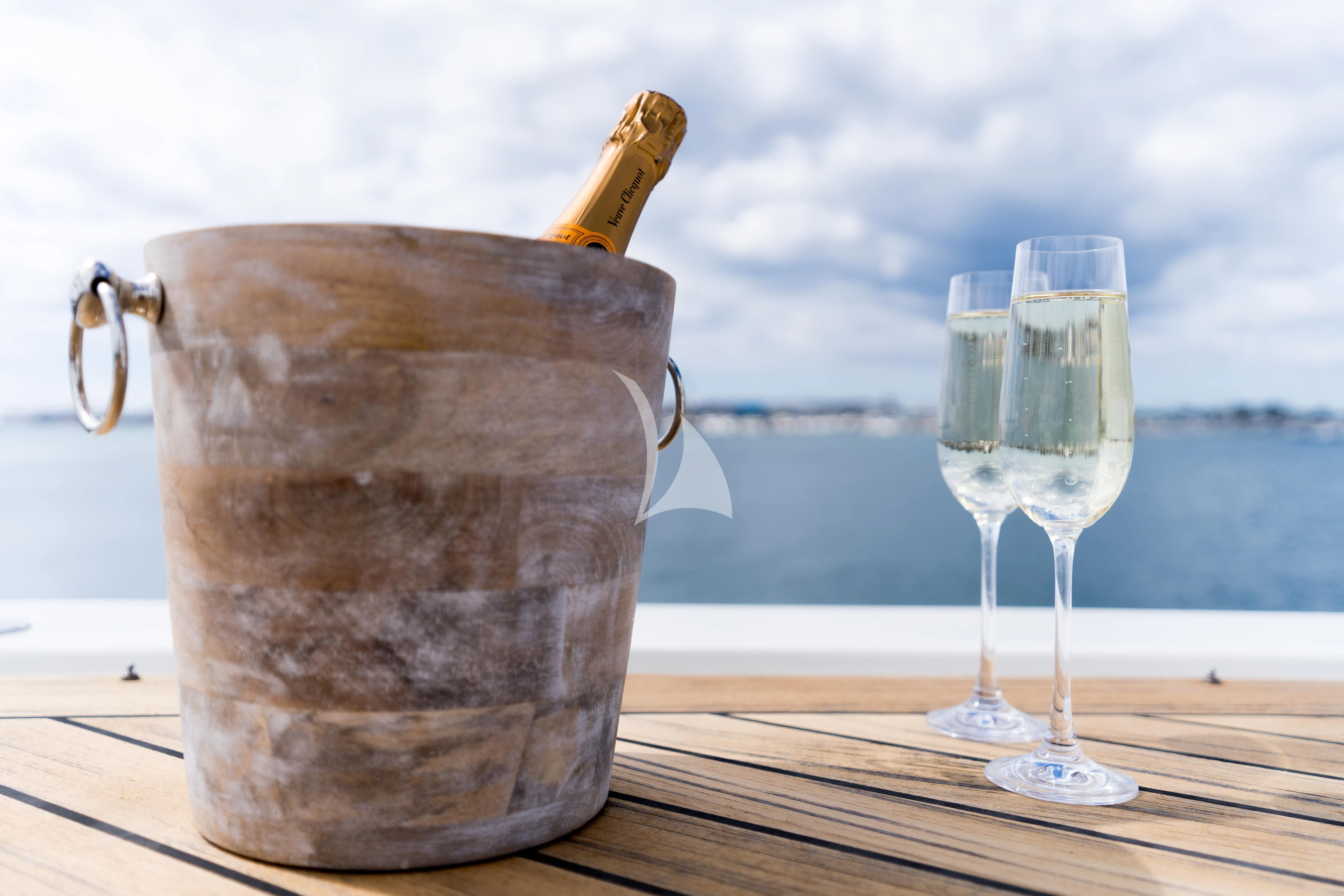 a glass of wine and a bottle aboard IRAMA Yacht for Sale