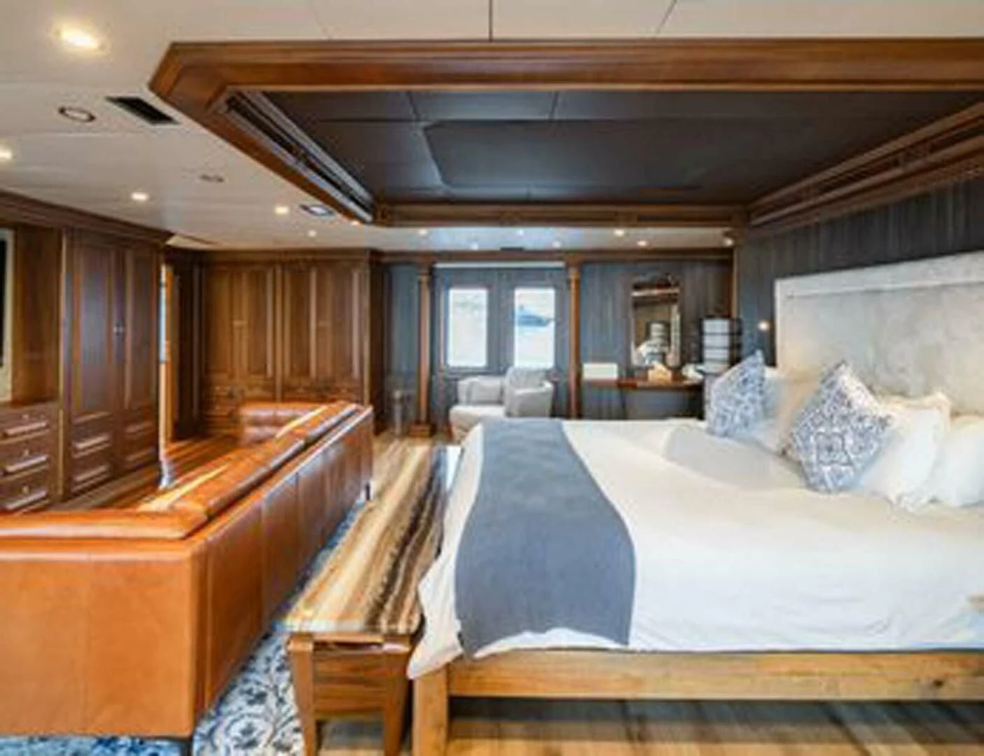 a room with a bed and a chair aboard IRAMA Yacht for Sale