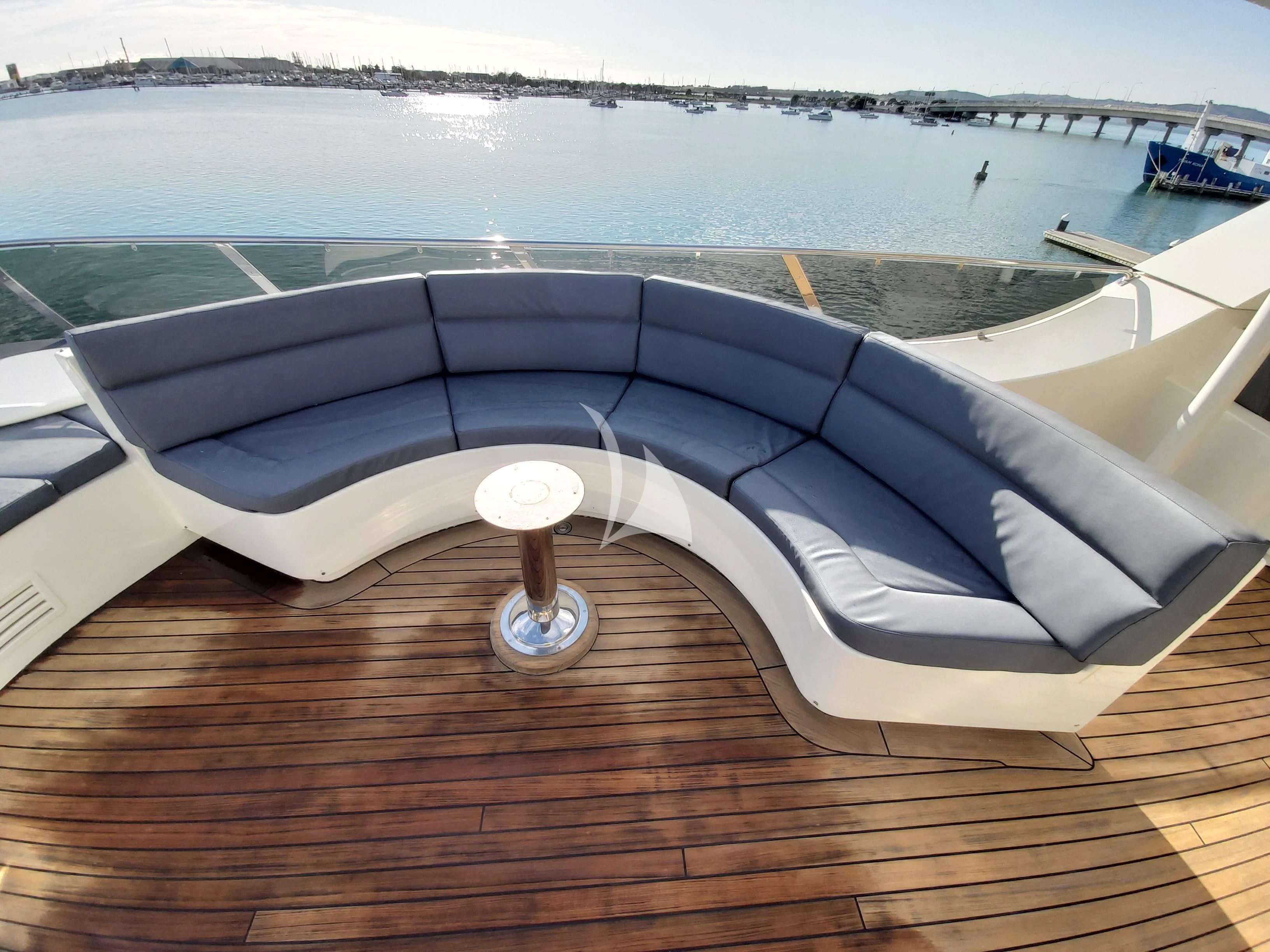 a large pool with a deck overlooking a beach aboard IRAMA Yacht for Sale
