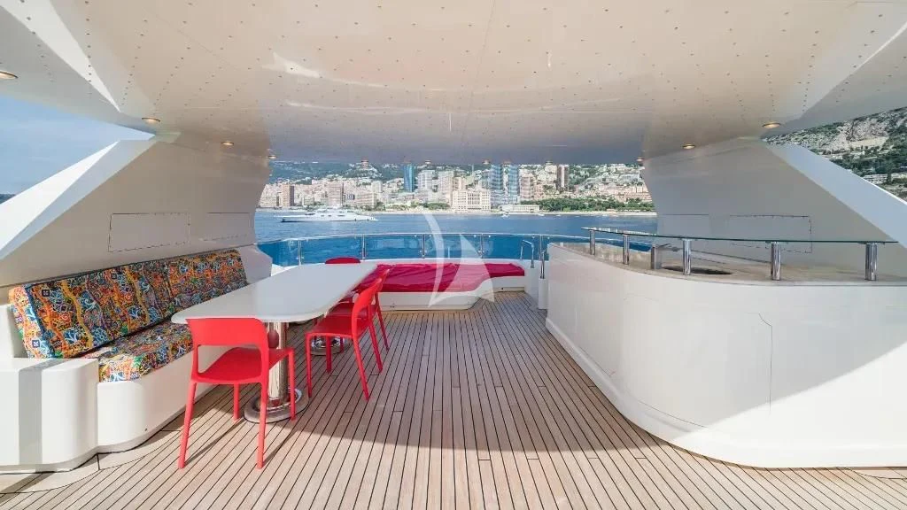 a room with a table chairs and a large window aboard IRAMA Yacht for Sale