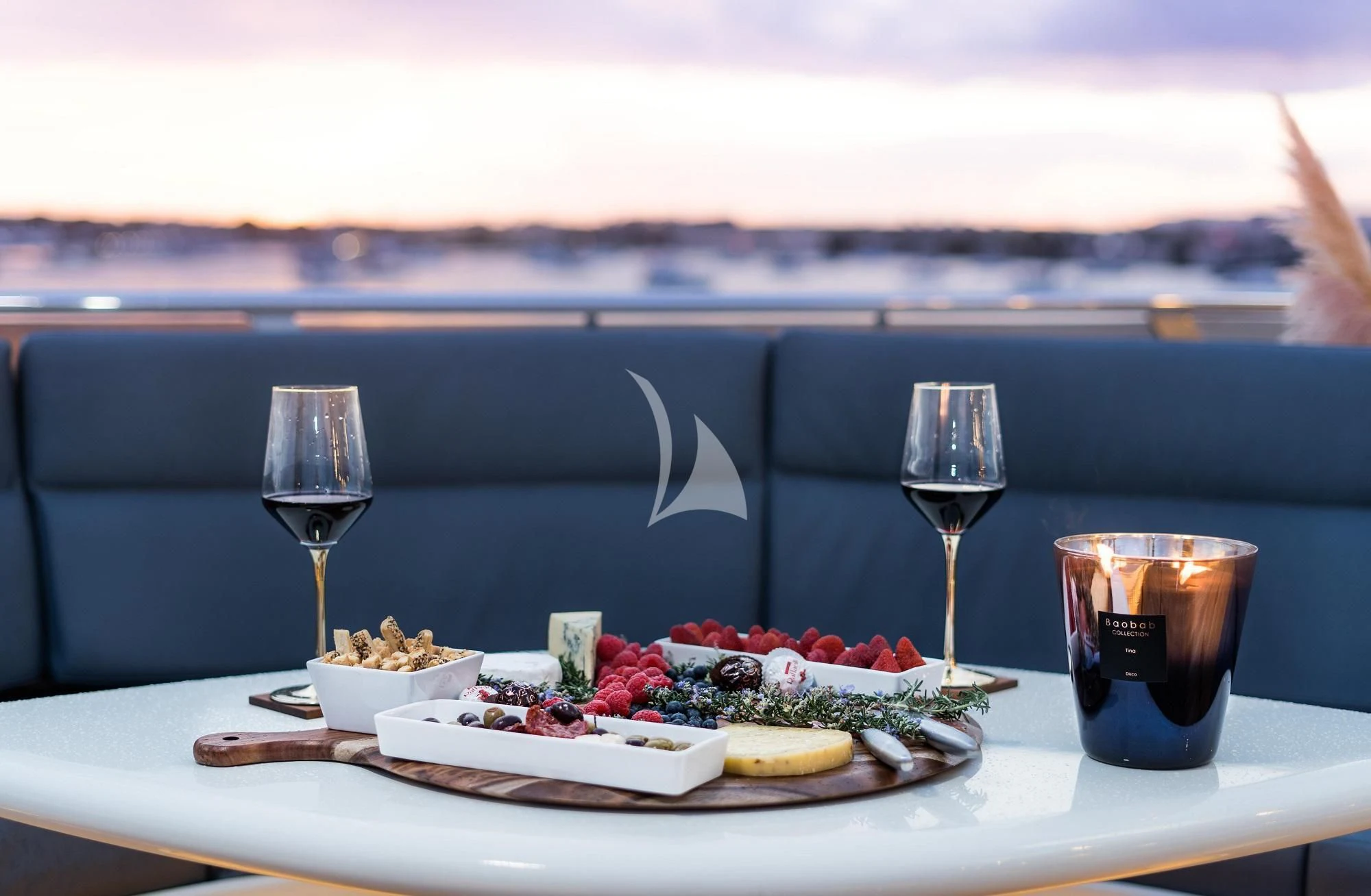 a table with food and drinks on it aboard IRAMA Yacht for Sale
