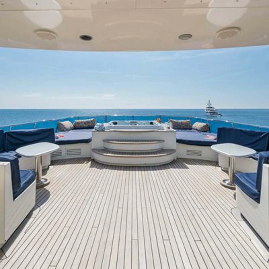 a room with a table and chairs aboard IRAMA Yacht for Sale