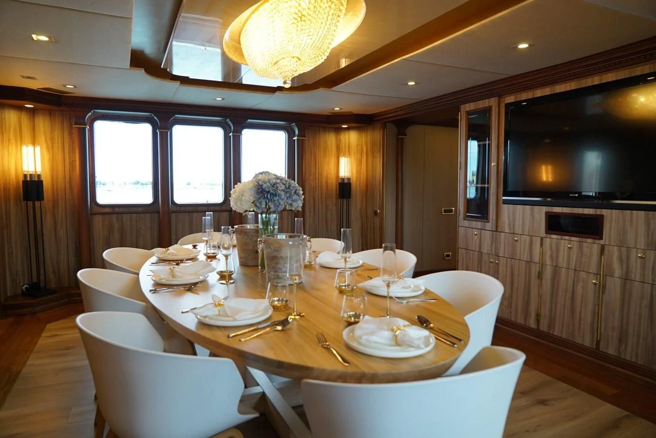 a dining room with a table set aboard IRAMA Yacht for Sale
