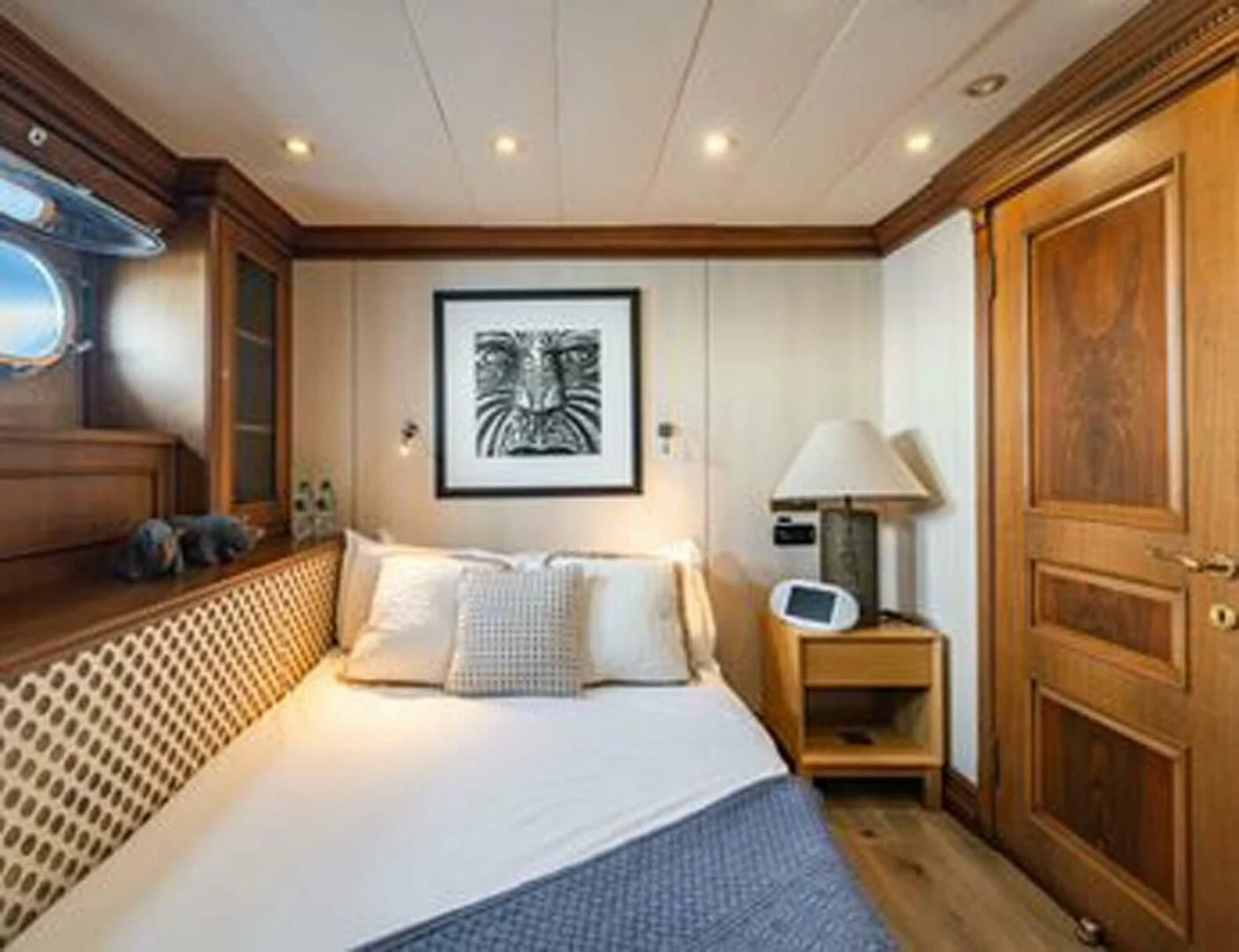a bedroom with a bed and a mirror aboard IRAMA Yacht for Sale
