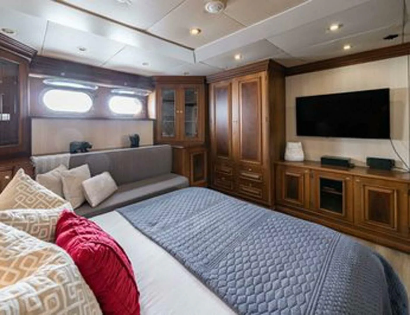a bedroom with a bed and a television aboard IRAMA Yacht for Sale