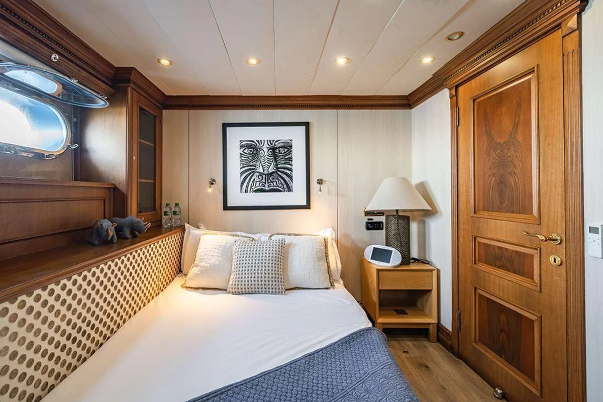 a bedroom with a bed and a desk aboard IRAMA Yacht for Sale