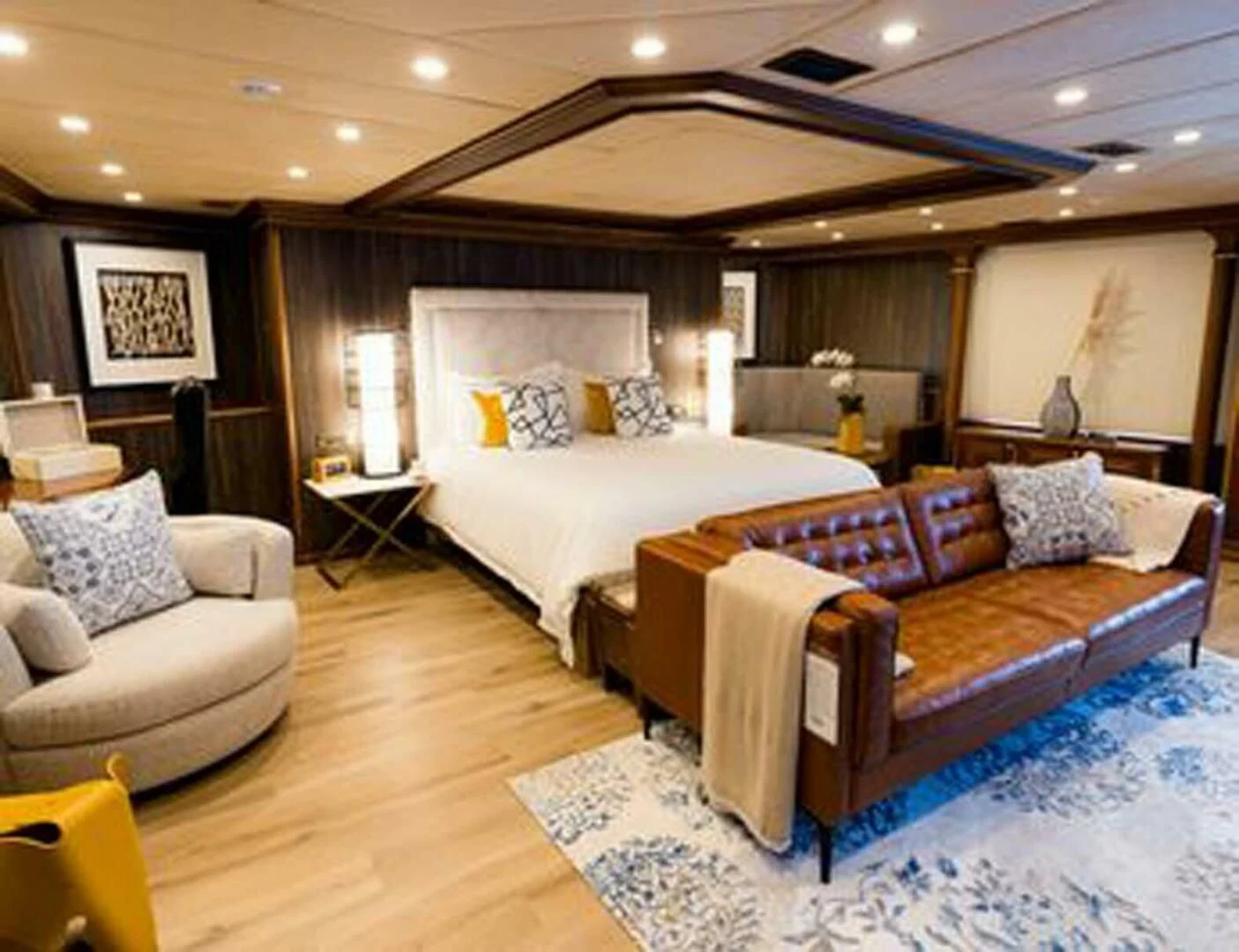 a room with a bed and a couch aboard IRAMA Yacht for Sale