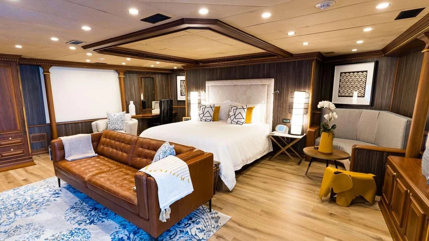 a room with a bed and a couch aboard IRAMA Yacht for Sale