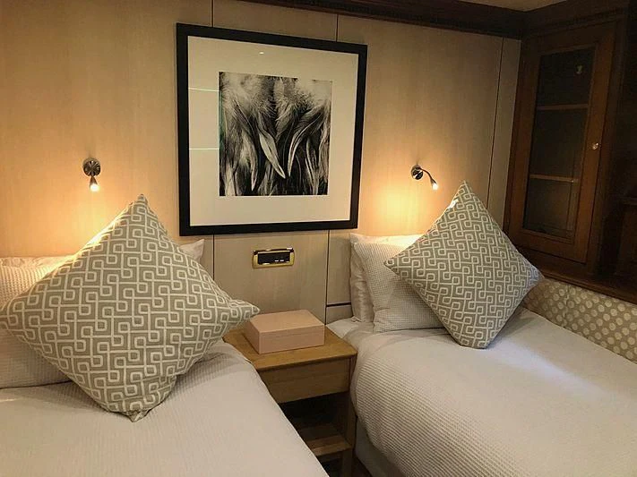 a room with a bed and a painting on the wall aboard IRAMA Yacht for Sale