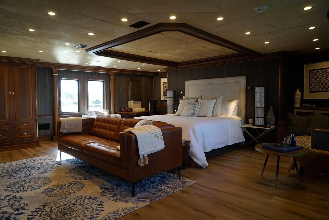a large bedroom with a bed and a couch aboard IRAMA Yacht for Sale