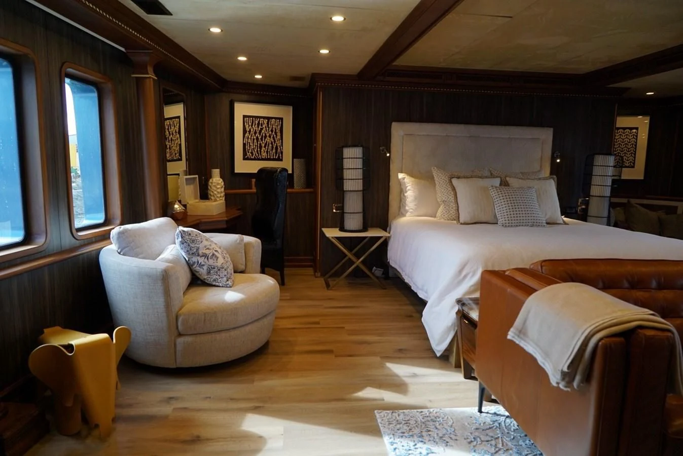 a room with a bed and a chair aboard IRAMA Yacht for Sale
