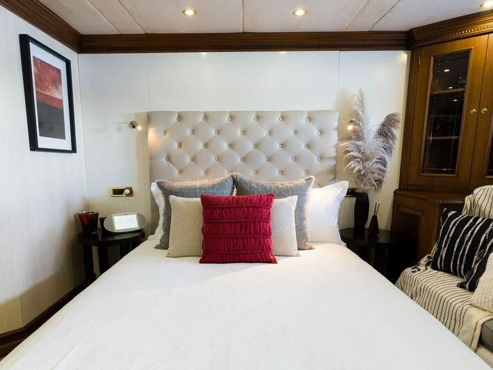 a bed with pillows aboard IRAMA Yacht for Sale