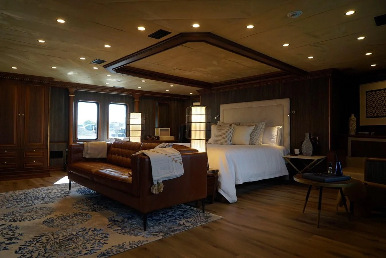 a bedroom with a bed and a couch aboard IRAMA Yacht for Sale