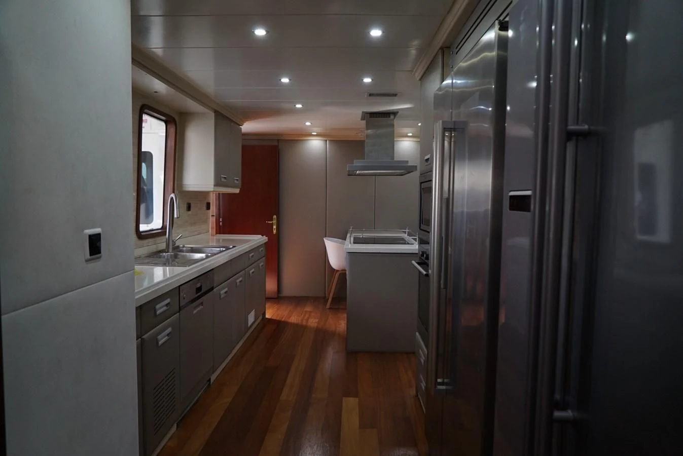 a kitchen with a large refrigerator aboard IRAMA Yacht for Sale