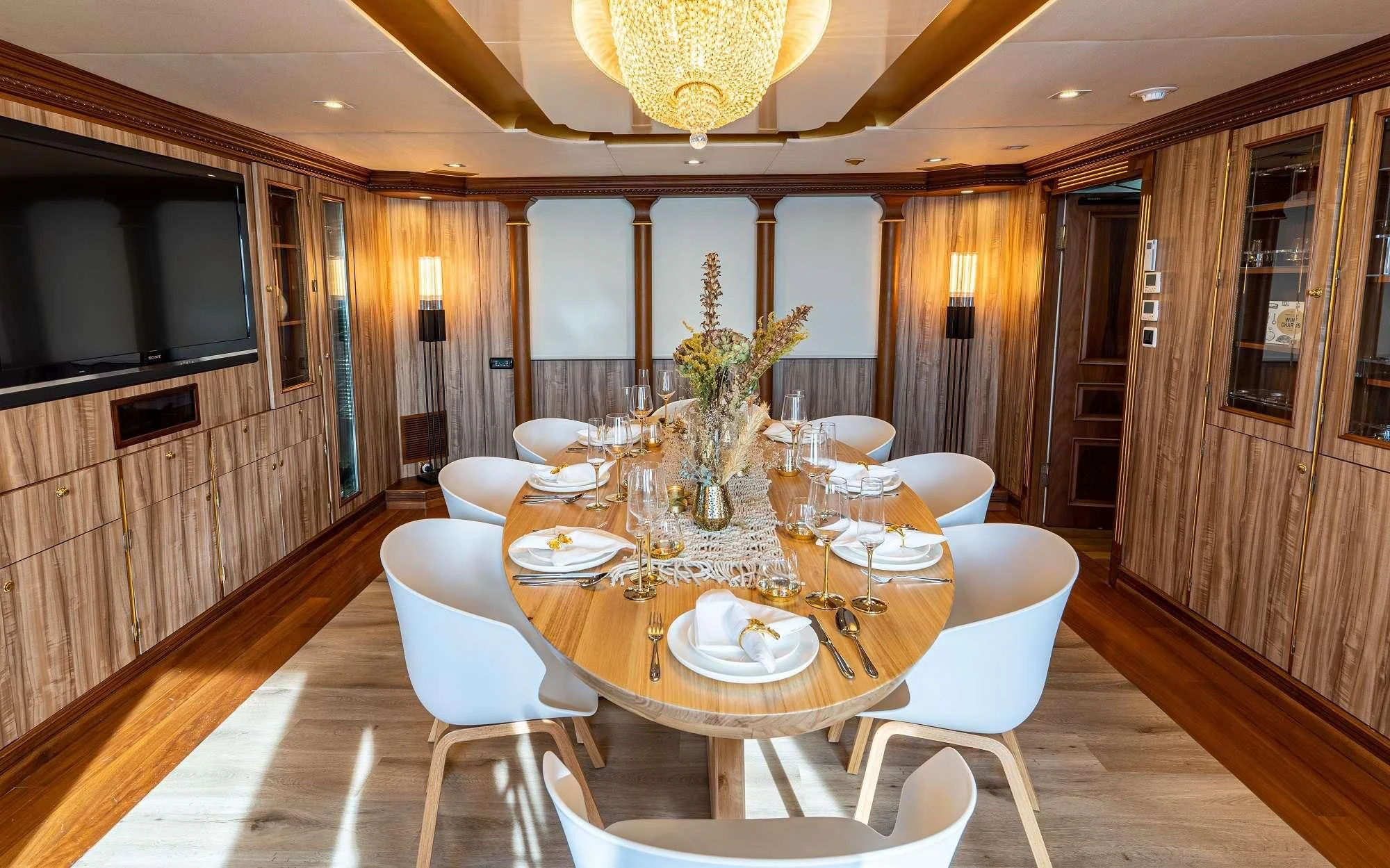 a dining room with a table and chairs aboard IRAMA Yacht for Sale