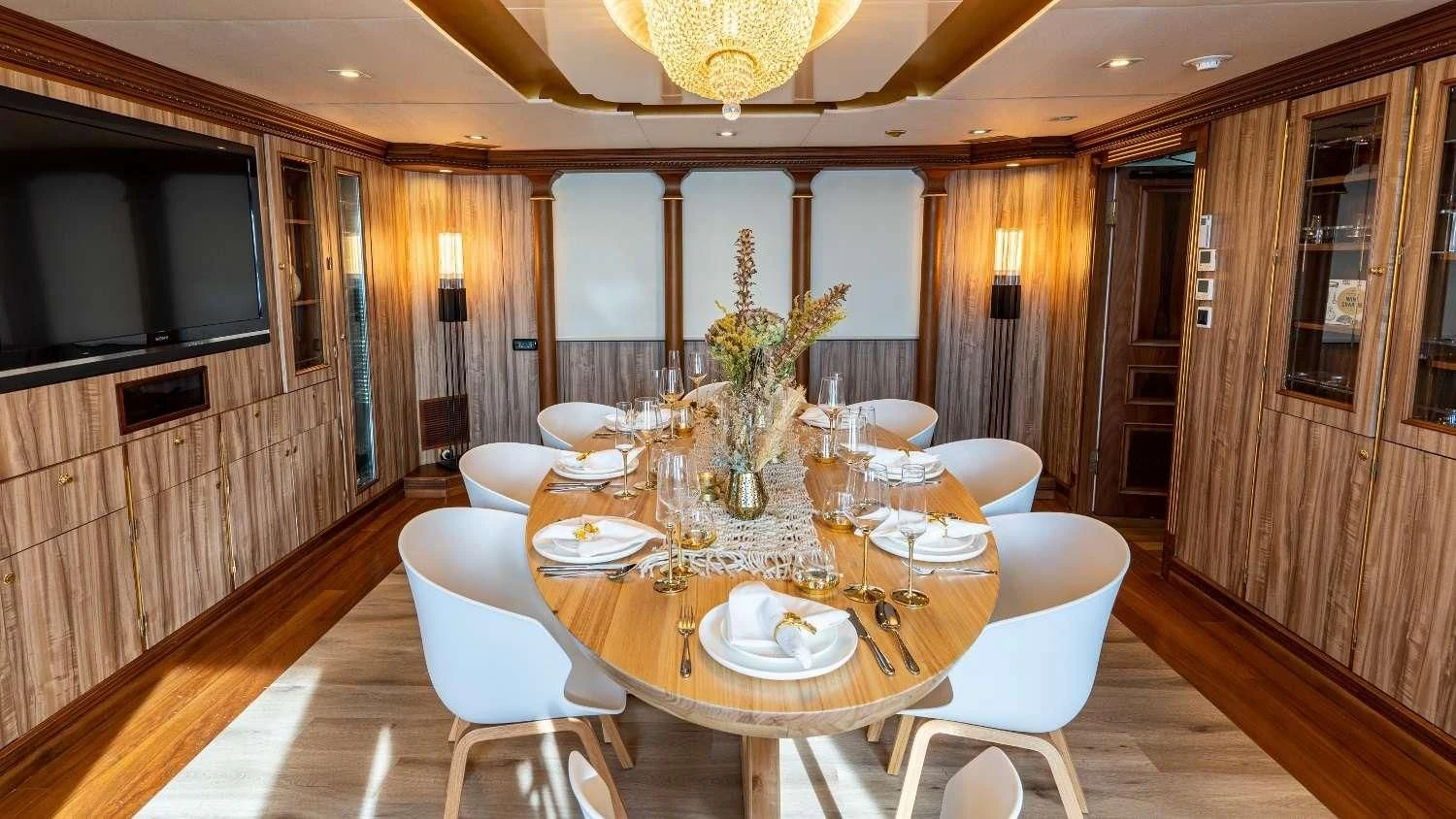 a dining room with a table and chairs aboard IRAMA Yacht for Sale