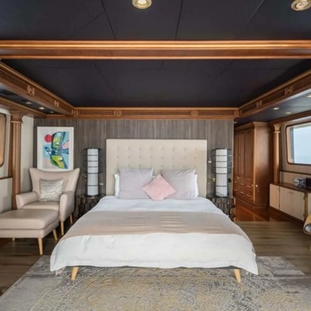 a bed with a white comforter aboard IRAMA Yacht for Sale