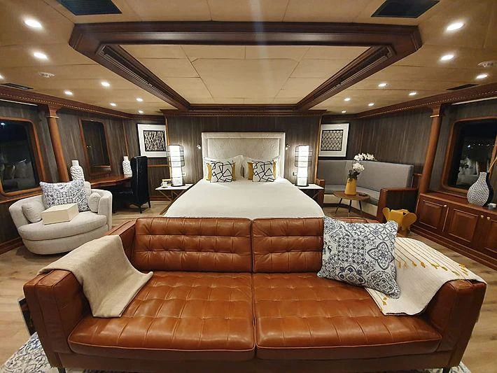 a living room with a couch and a tv aboard IRAMA Yacht for Sale