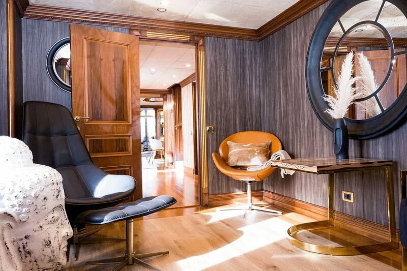a room with a mirror and a chair aboard IRAMA Yacht for Sale
