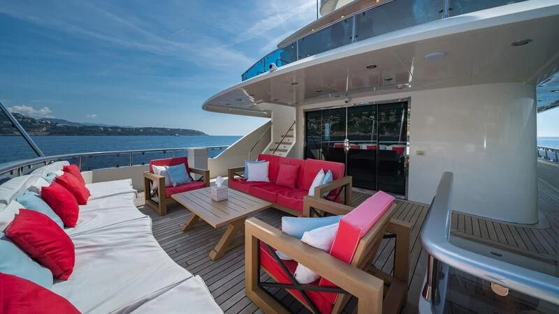 a room with a bed and a table and chairs aboard IRAMA Yacht for Sale