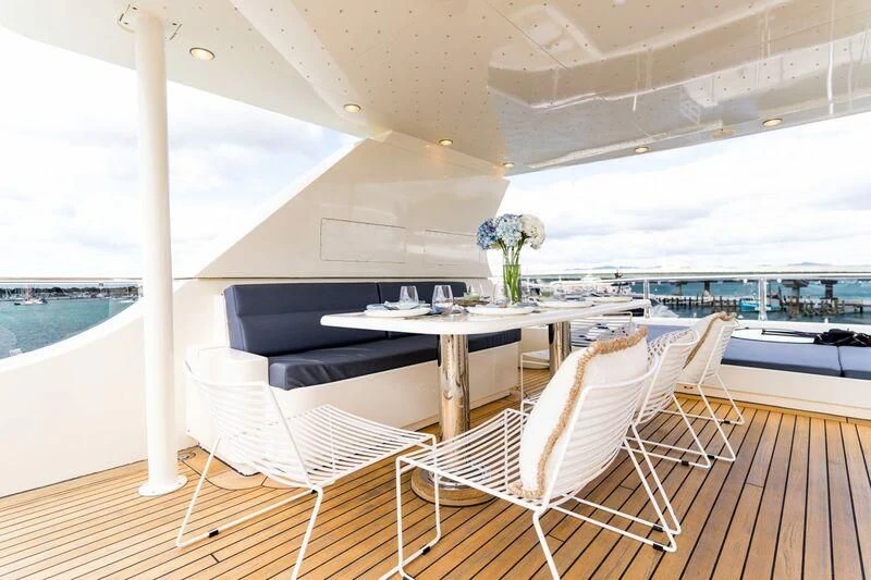 a room with a table and chairs aboard IRAMA Yacht for Sale