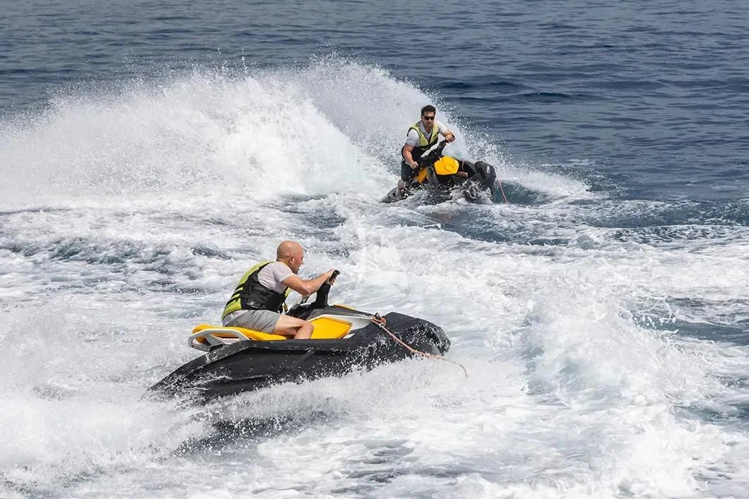 a couple of people in kayaks in the water aboard IRAMA Yacht for Sale