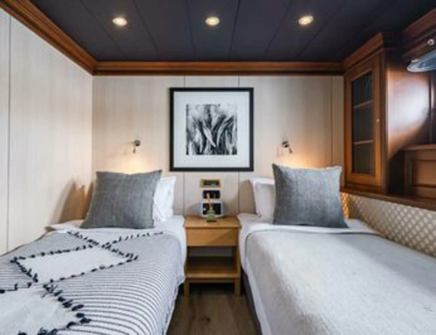a bedroom with two beds aboard IRAMA Yacht for Sale