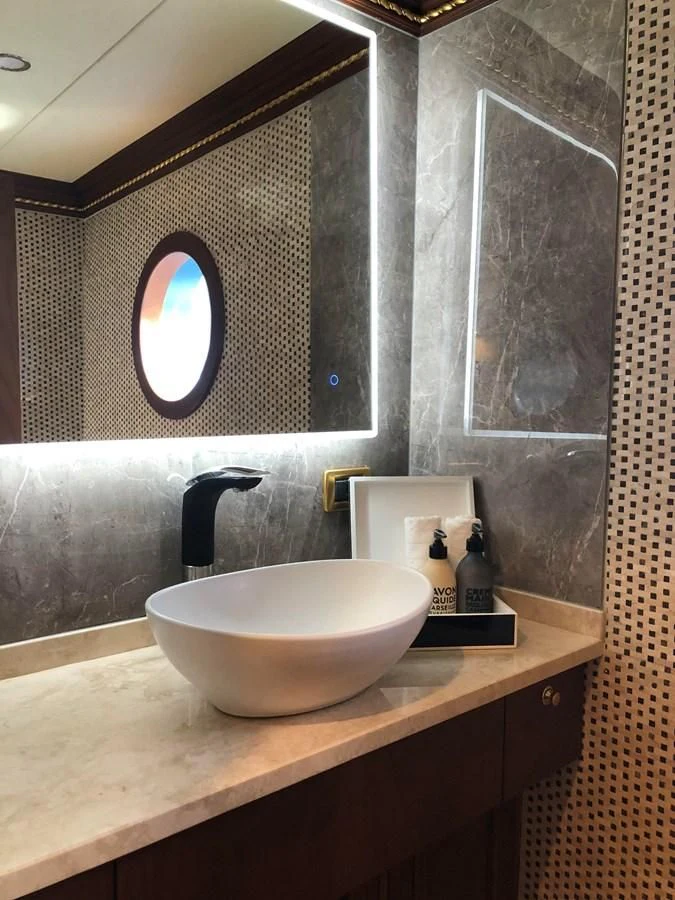 a bathroom with a sink and a mirror aboard IRAMA Yacht for Sale