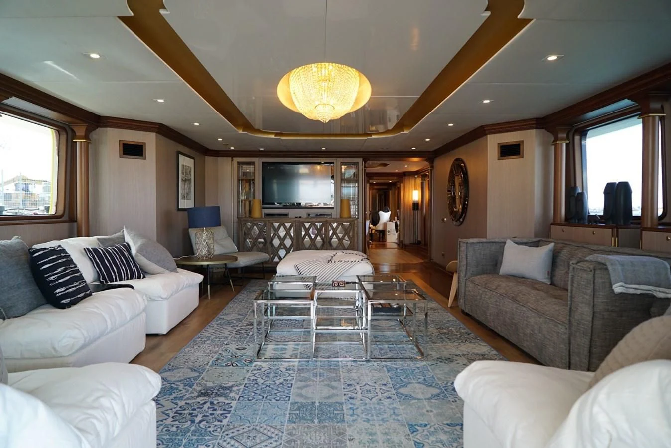 a large living room with a large blue rug aboard IRAMA Yacht for Sale