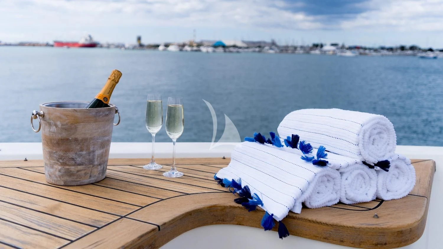 a cake and glasses on a table aboard IRAMA Yacht for Sale