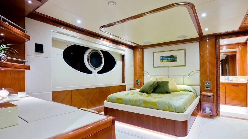 a room with a bed and a large mirror aboard GRAND CRU Yacht for Sale
