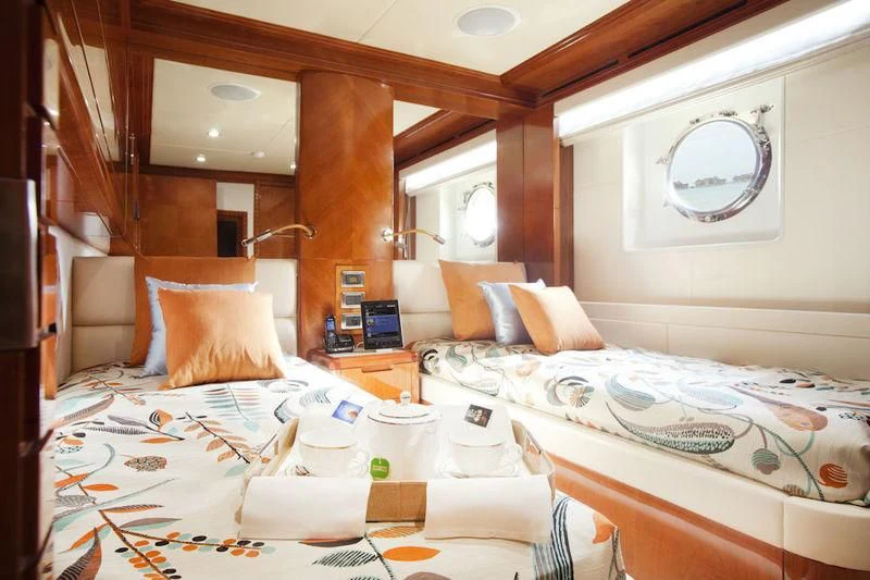 a room with beds and a mirror aboard GRAND CRU Yacht for Sale
