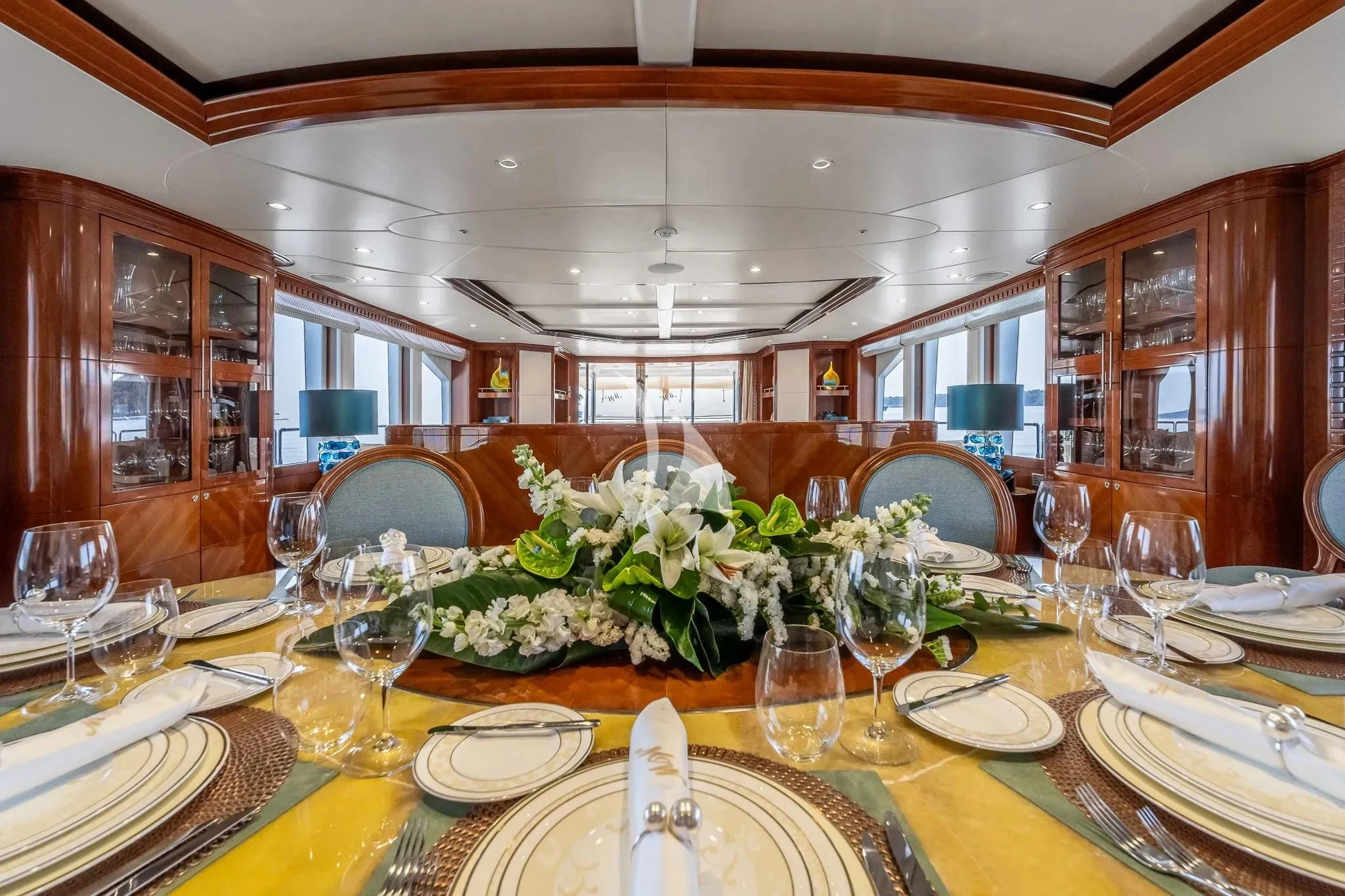 a dining room with a table set for a formal dinner aboard GRAND CRU Yacht for Sale
