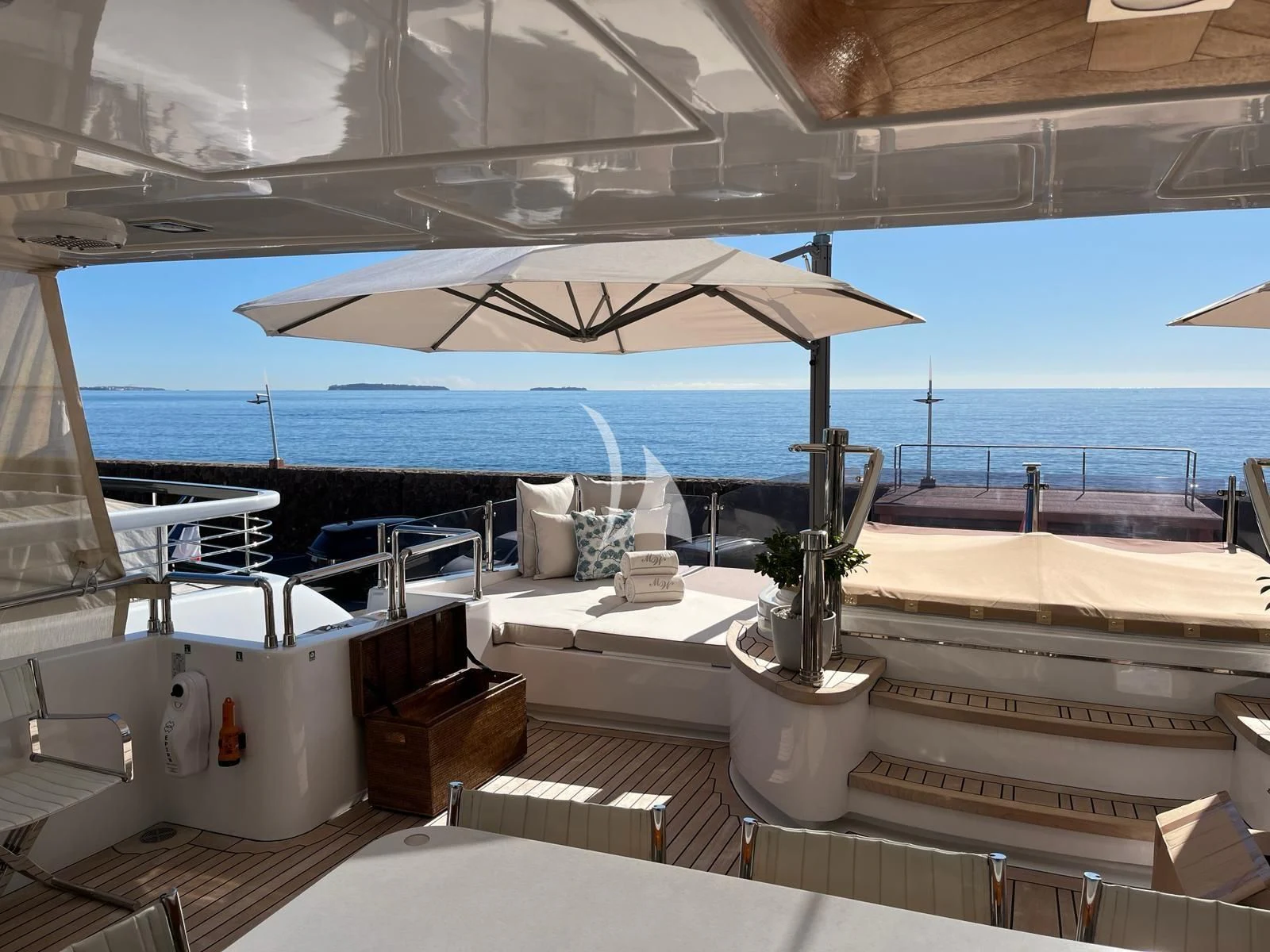 a patio with a table and chairs on it aboard GRAND CRU Yacht for Sale