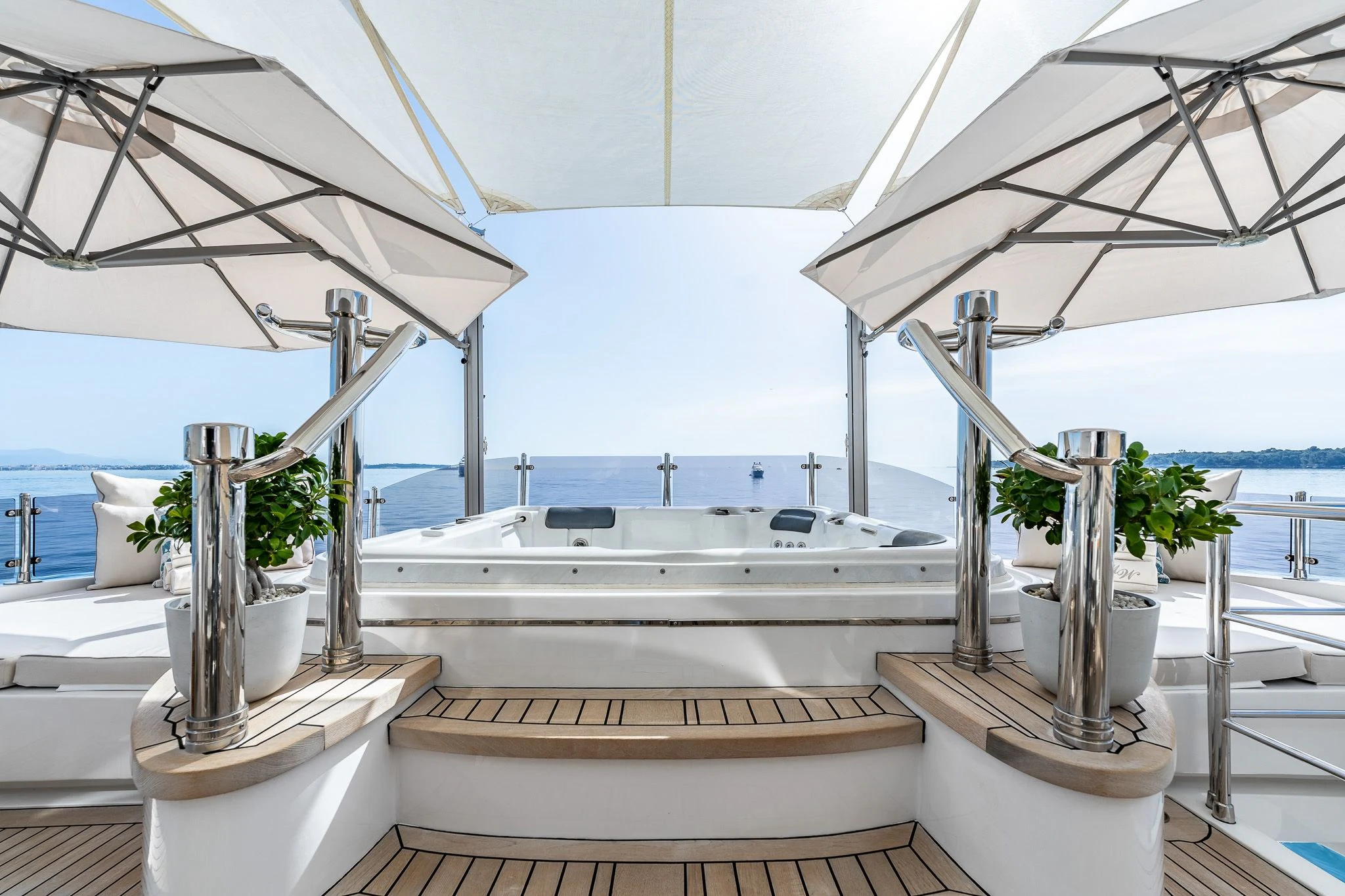 a large white room with a large white tub and plants aboard GRAND CRU Yacht for Sale