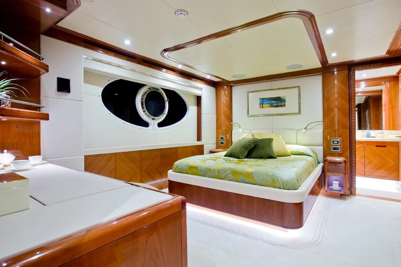 a room with a bed and a large mirror aboard GRAND CRU Yacht for Sale