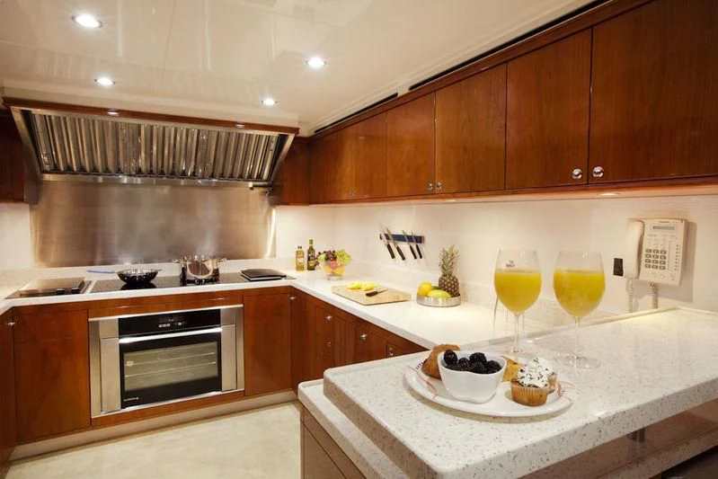 a kitchen with wooden cabinets aboard GRAND CRU Yacht for Sale