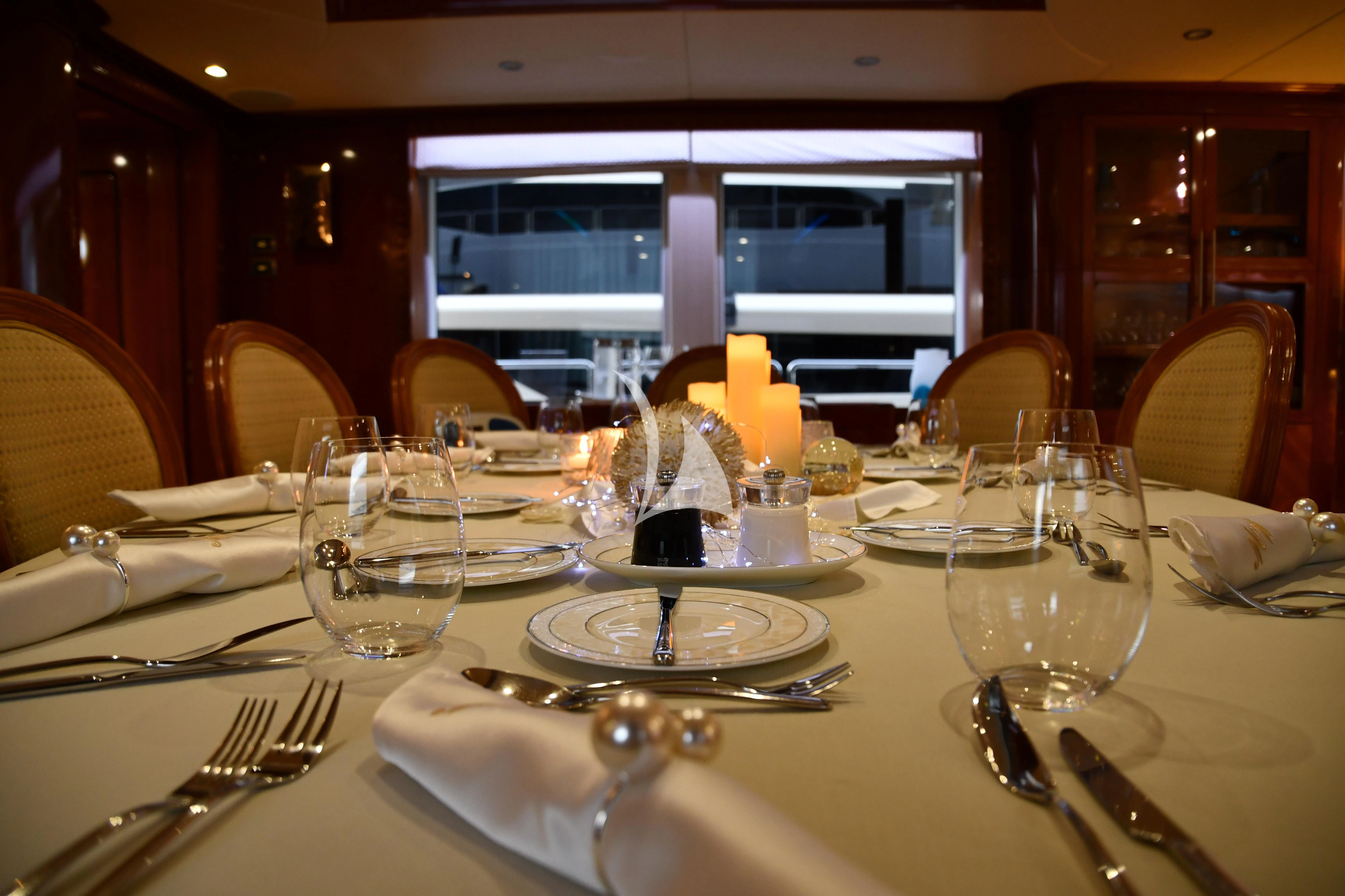 a table with plates and glasses aboard GRAND CRU Yacht for Sale