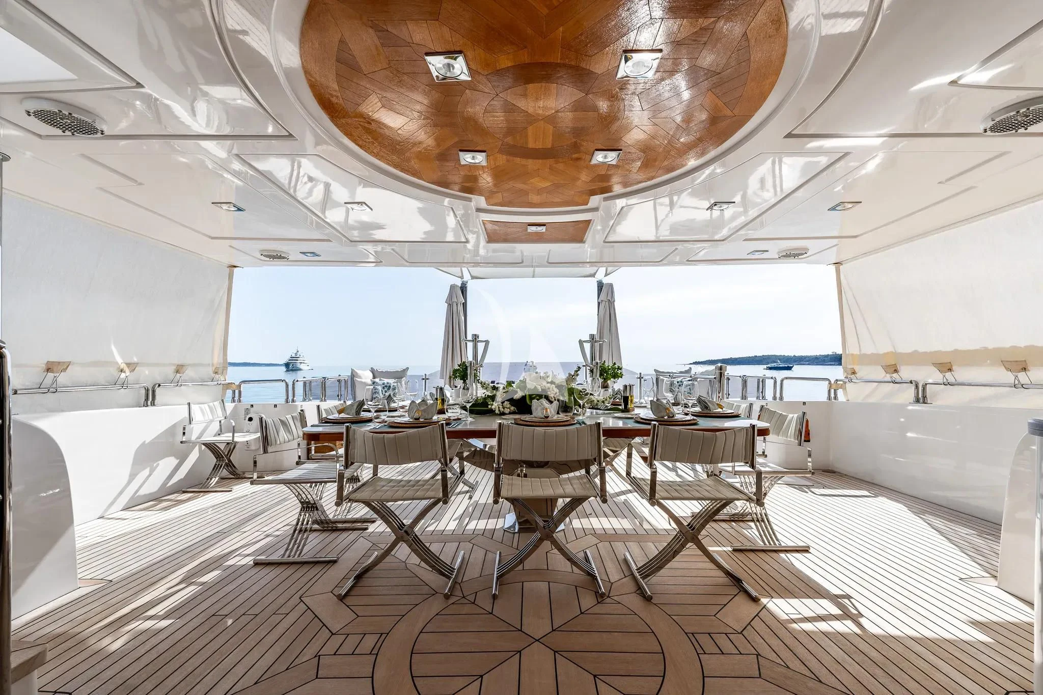 a room with tables and chairs aboard GRAND CRU Yacht for Sale