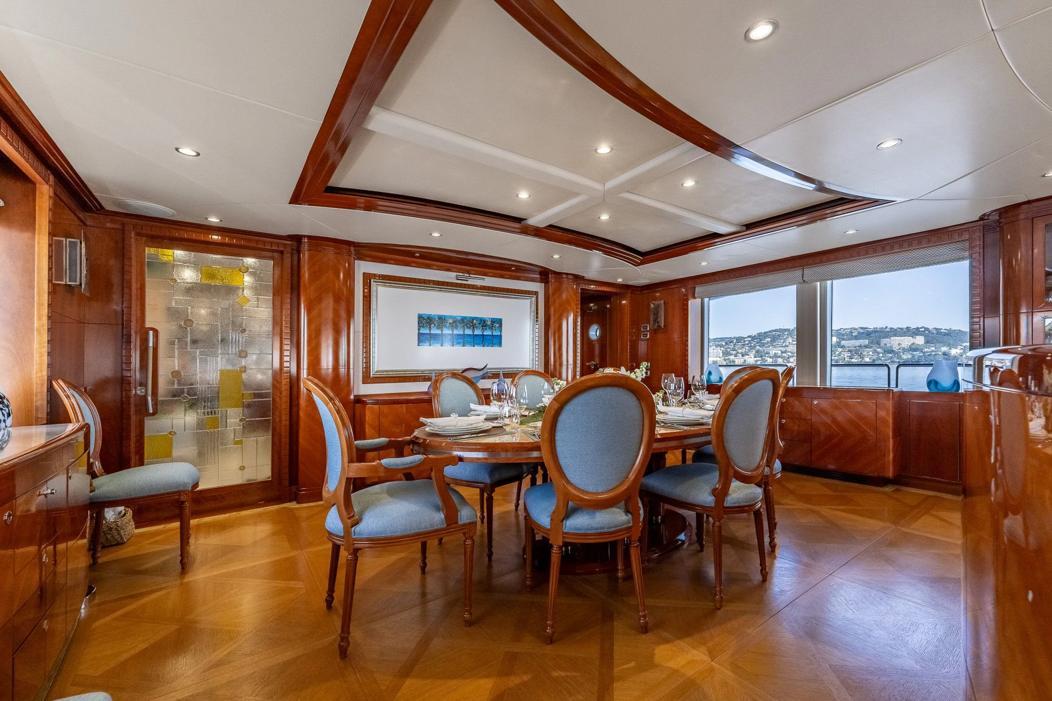 a large dining room with wood floors aboard GRAND CRU Yacht for Sale