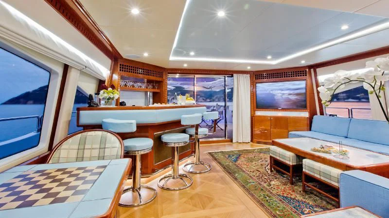 a room with a table chairs and a couch aboard GRAND CRU Yacht for Sale