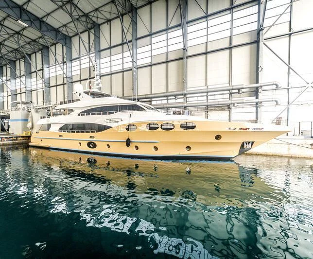 a yellow boat in a large building aboard GRAND CRU Yacht for Sale