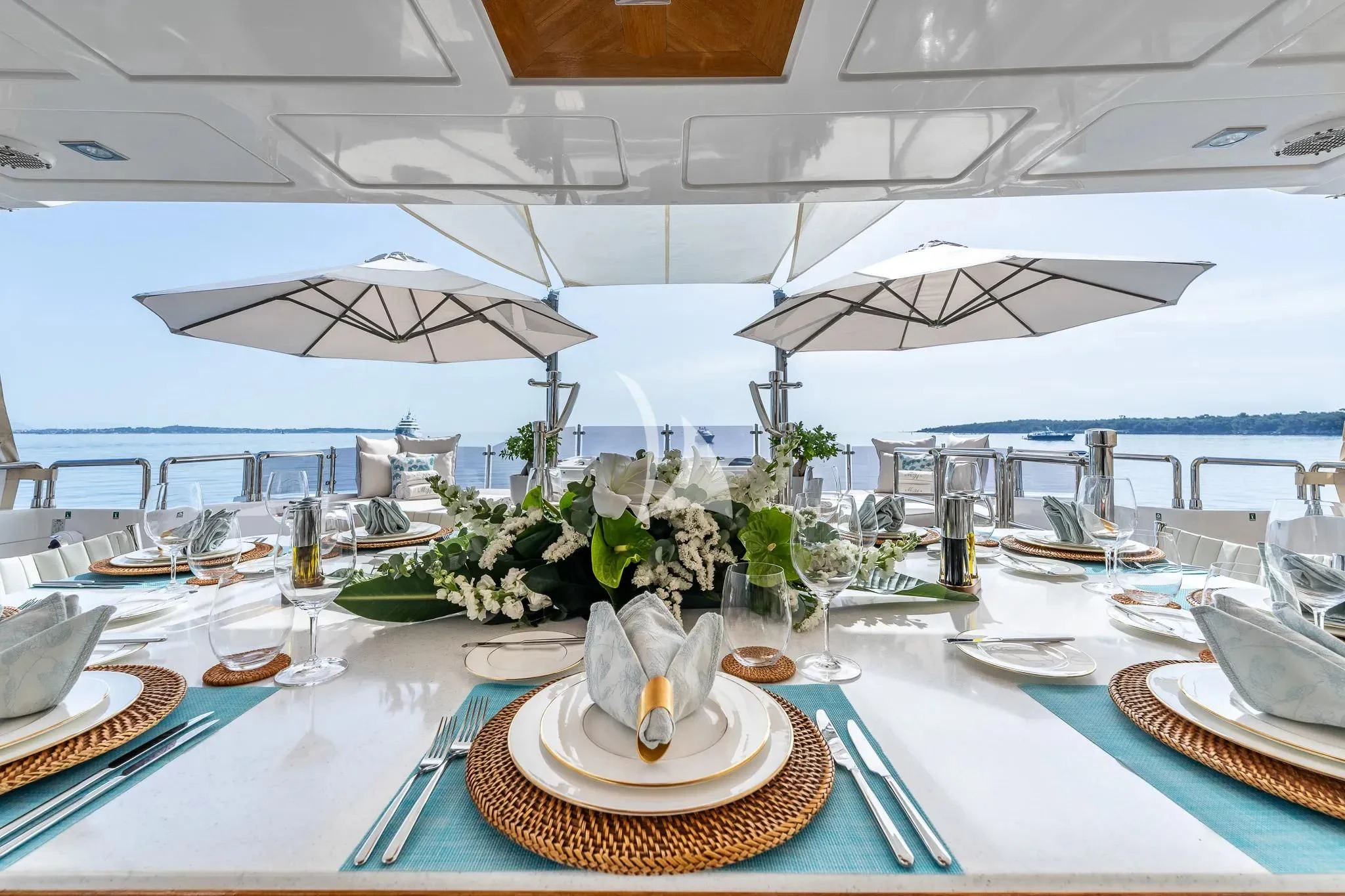 a table with plates and glasses aboard GRAND CRU Yacht for Sale